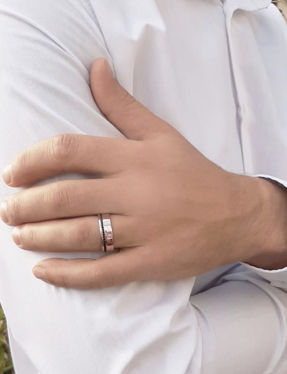 Refined rose gold men’s ring with offset black diamonds.