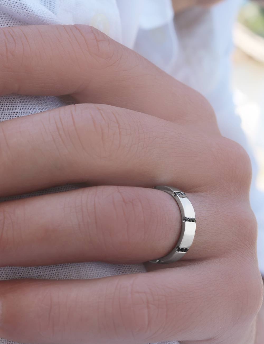 Luxury men's wedding band with 8 rows of black diamonds, symbolizing the eternal union of two souls.