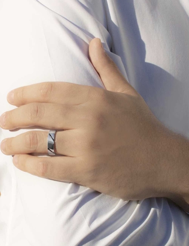 A unique wedding ring for men, with black diamonds set in diagonal around the band