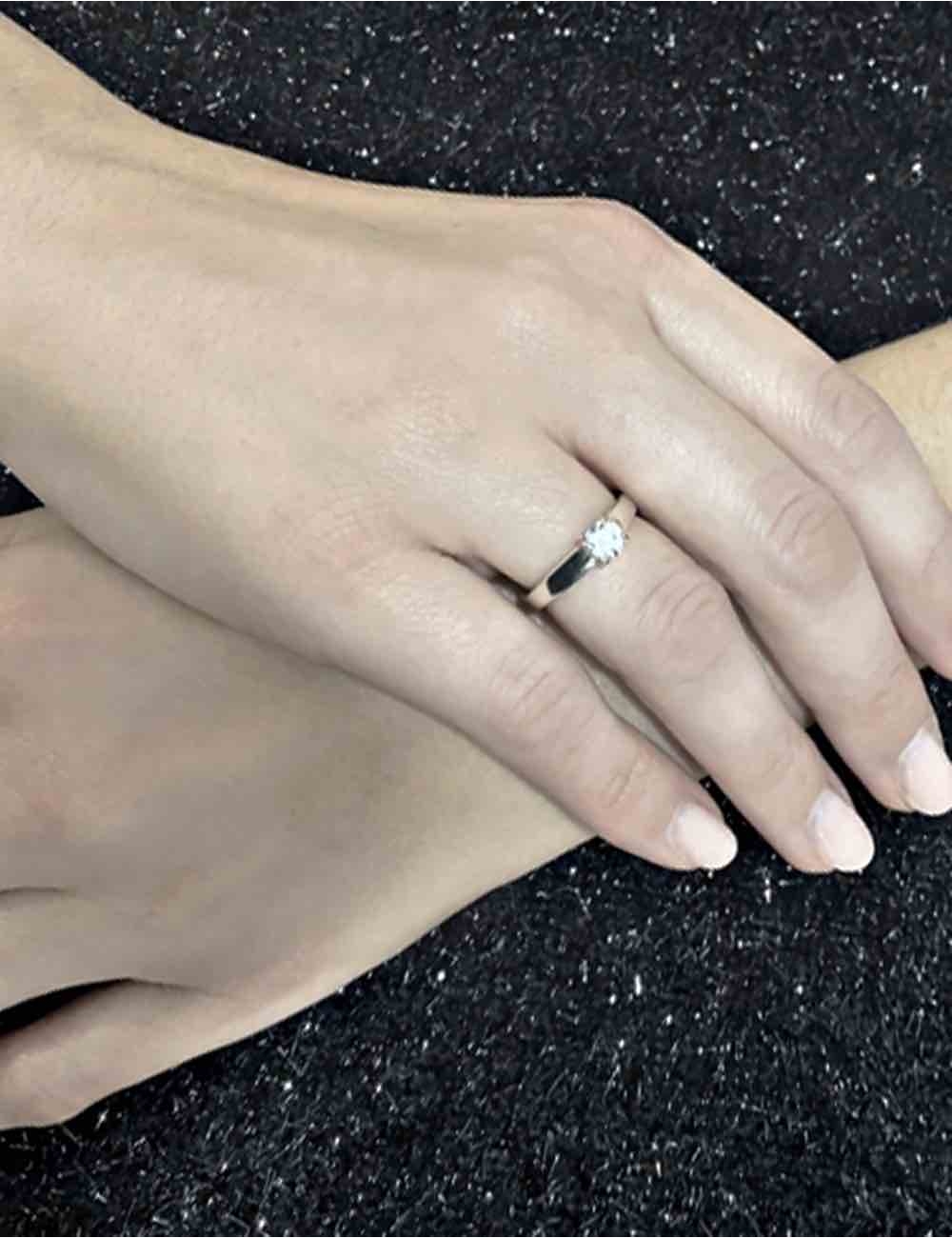 Modern platinum solitaire ring with 0.50 ct white diamond, sleek design for timeless elegance.