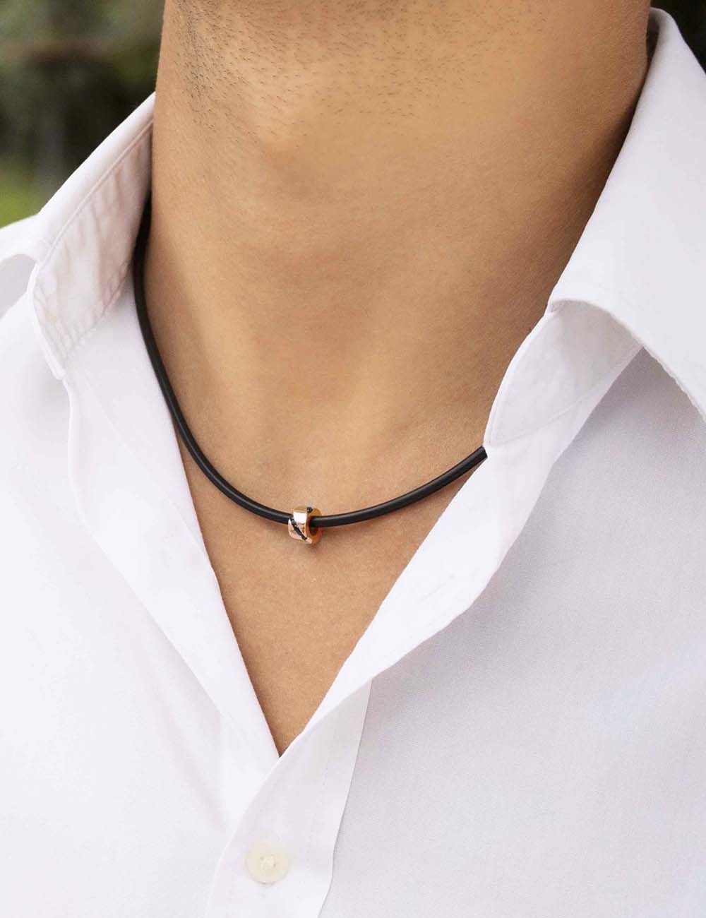 Rose gold necklace for men, set with black diamonds, on black cord and gold clasp.