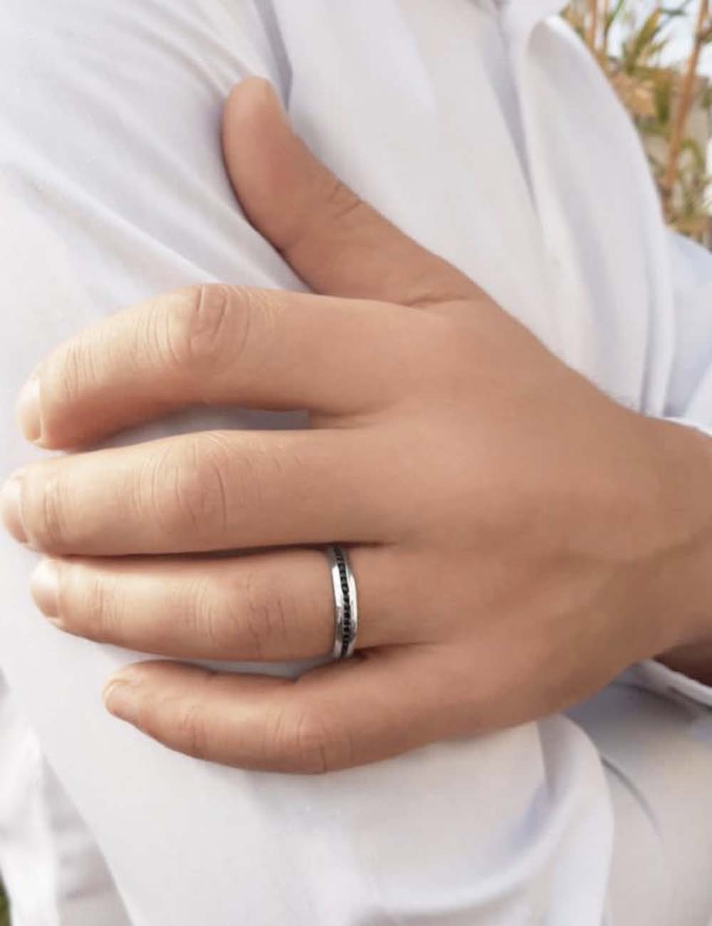 Traditional and creative men's wedding ring in platinum with set black diamonds, made in France.