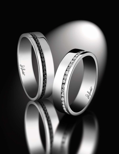 A wedding ring for men ultra modern and elegant with the offset line of black diamonds.