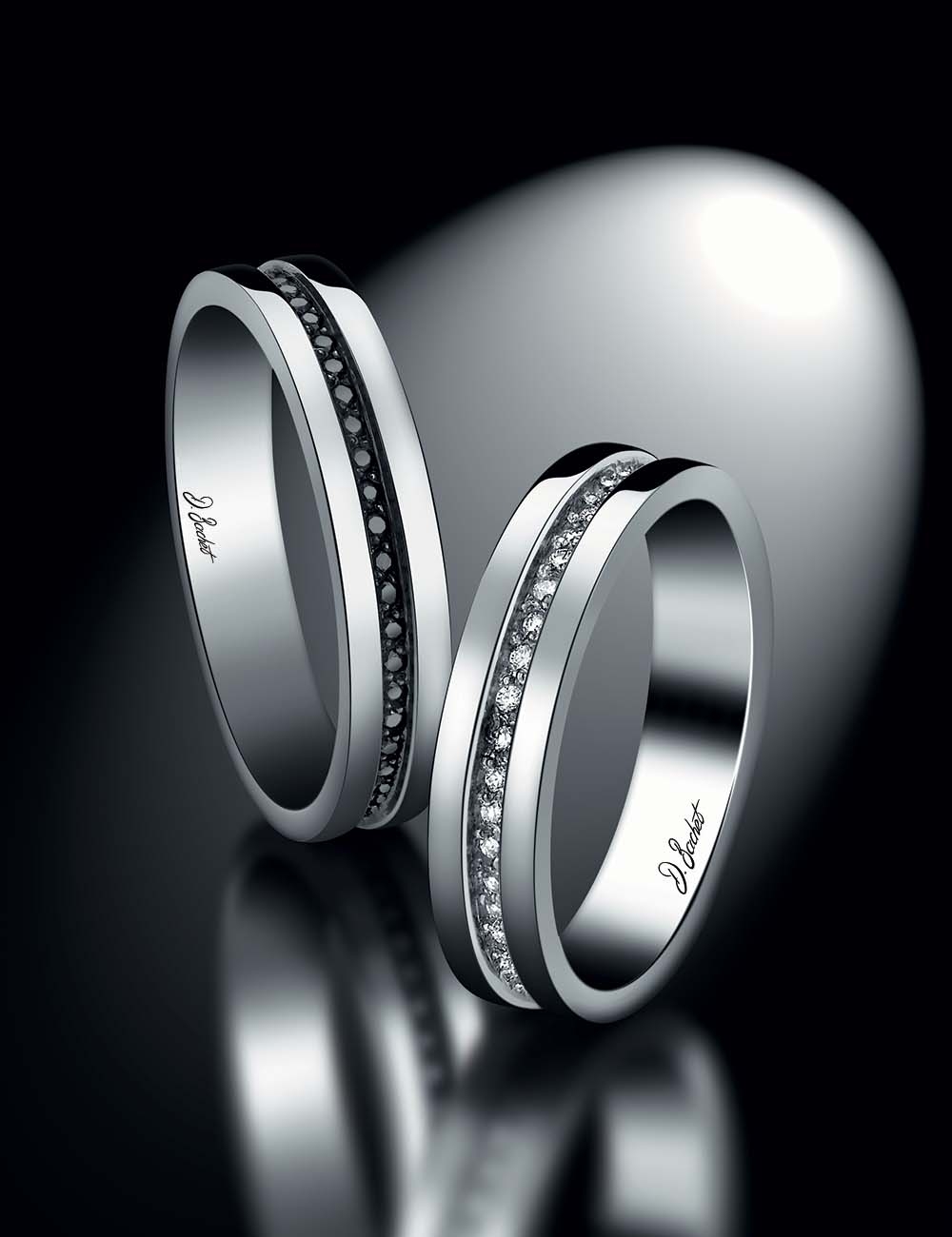 Modern men's platinum wedding band with black diamonds, sleek design, timeless elegance, and contrasting depth and volume.