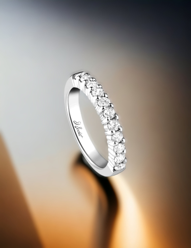 Woman's wedding band featuring sparkling prong-set white diamonds, highlighting delicate craftsmanship.