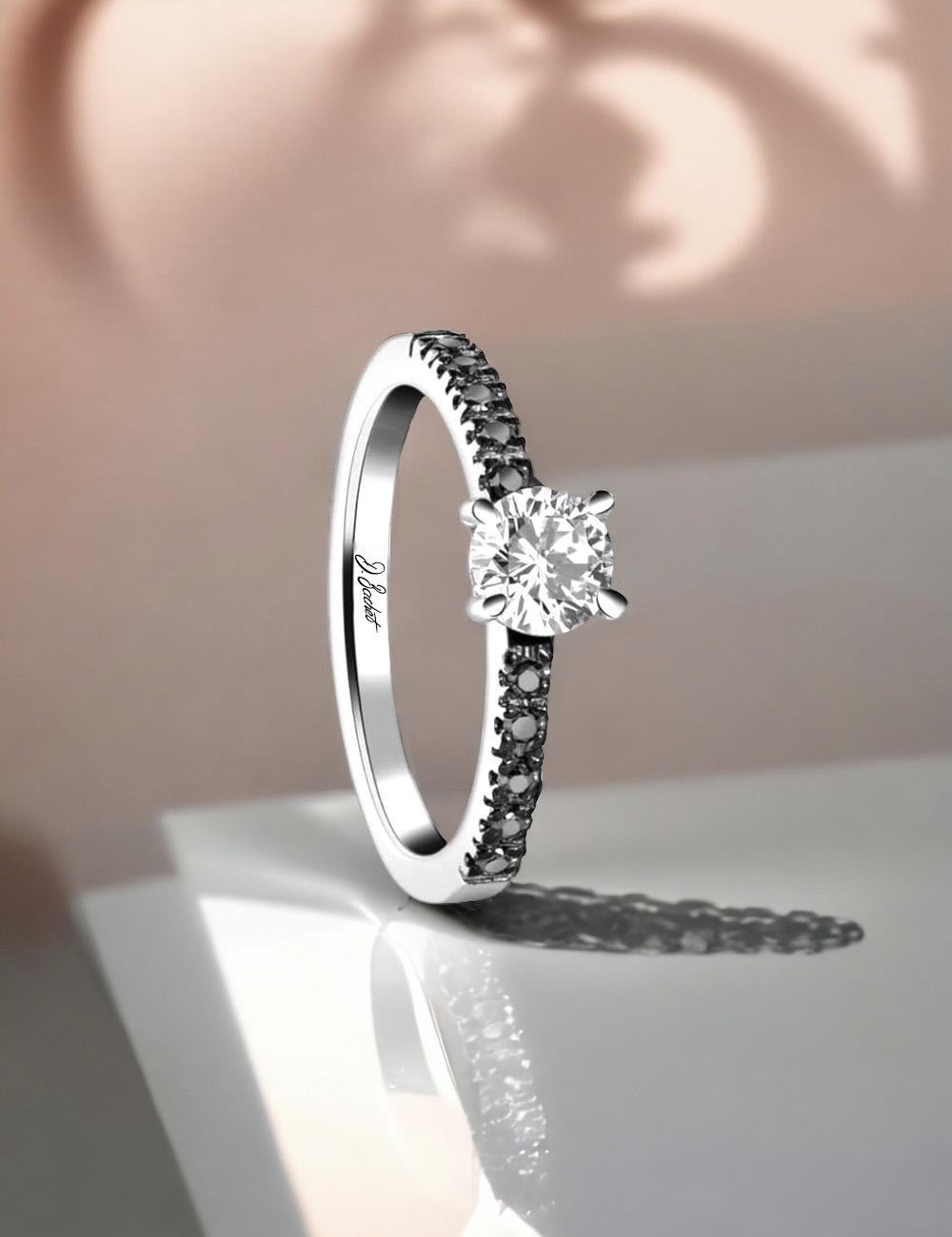 Engagement ring: platinum, central white diamond, black diamond pavé, prong setting.
