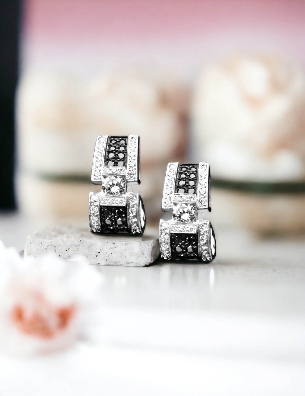 White gold earrings with black and white diamonds for timeless luxury.