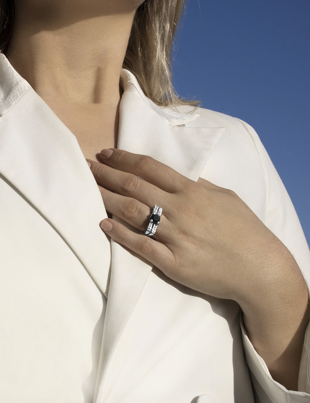 Platinum ring with a black diamond surrounded by white diamonds, echoing New York's architectural boldness.
