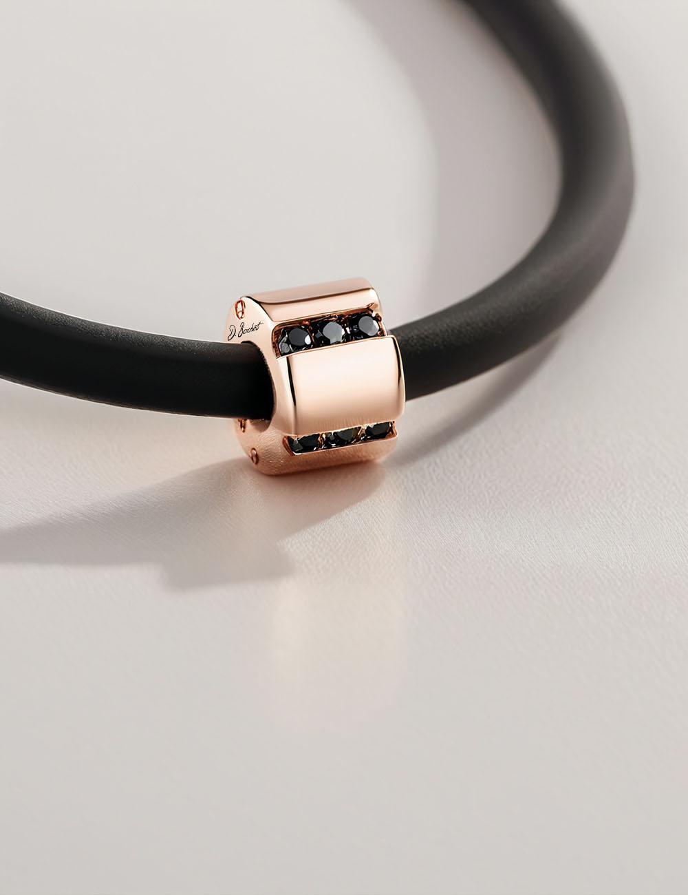 Rose gold A Bridge to Unity pendant with black diamonds, an elegant and graphic men's jewelry piece.
