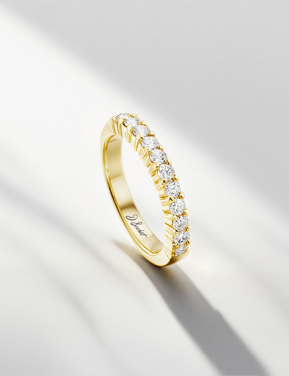 Yellow gold wedding band with prong-set natural white diamonds, timeless and radiant ring.