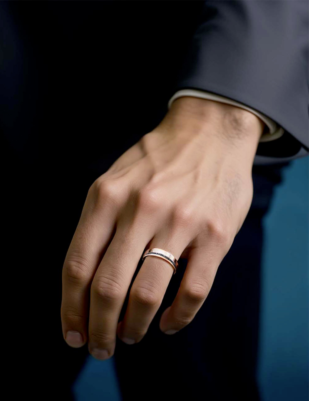 Rose gold flat band ring for men, graphic style with a refined offset black diamond setting.