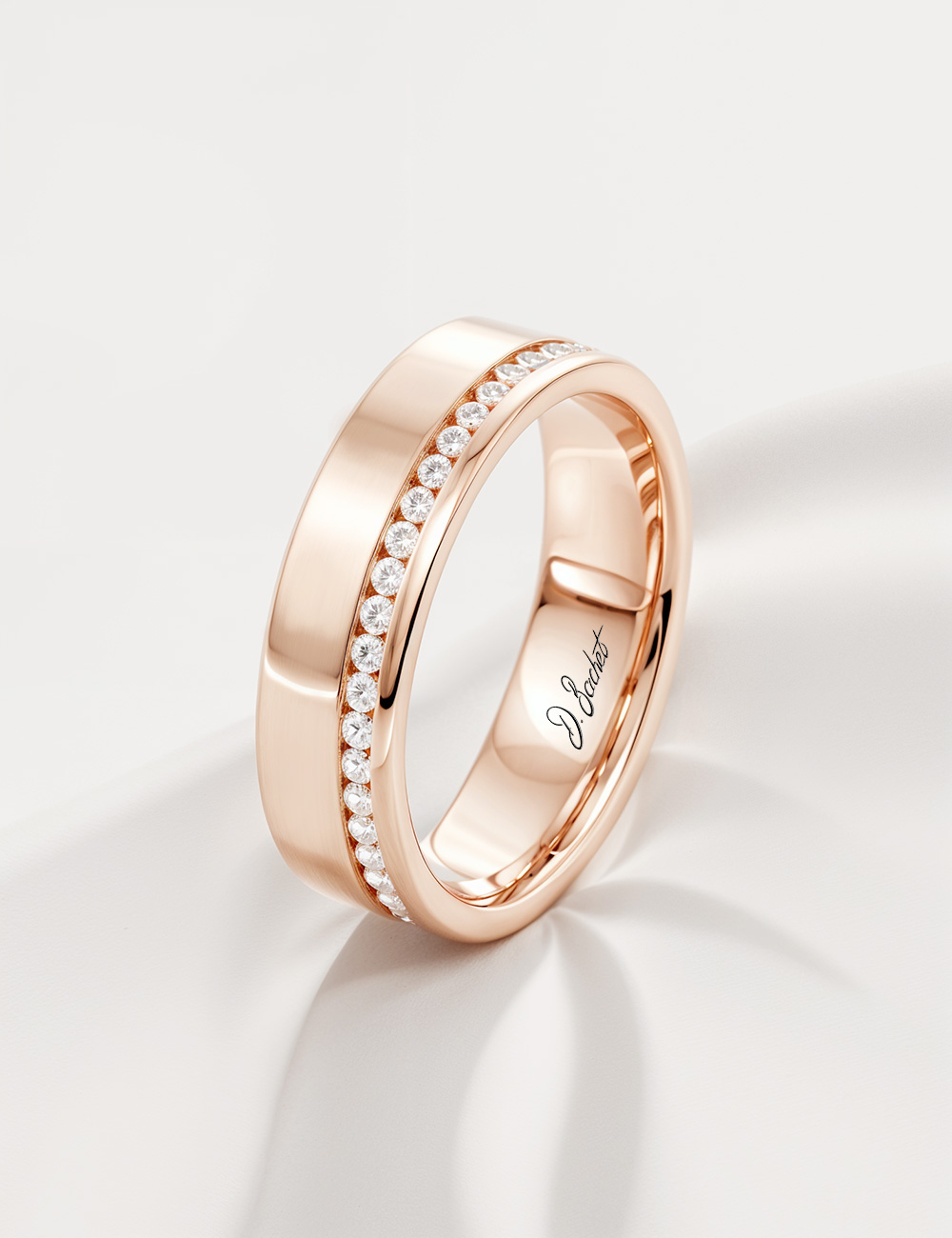 A flat and wide eternity wedding ring for women, in rose gold and white diamonds.
