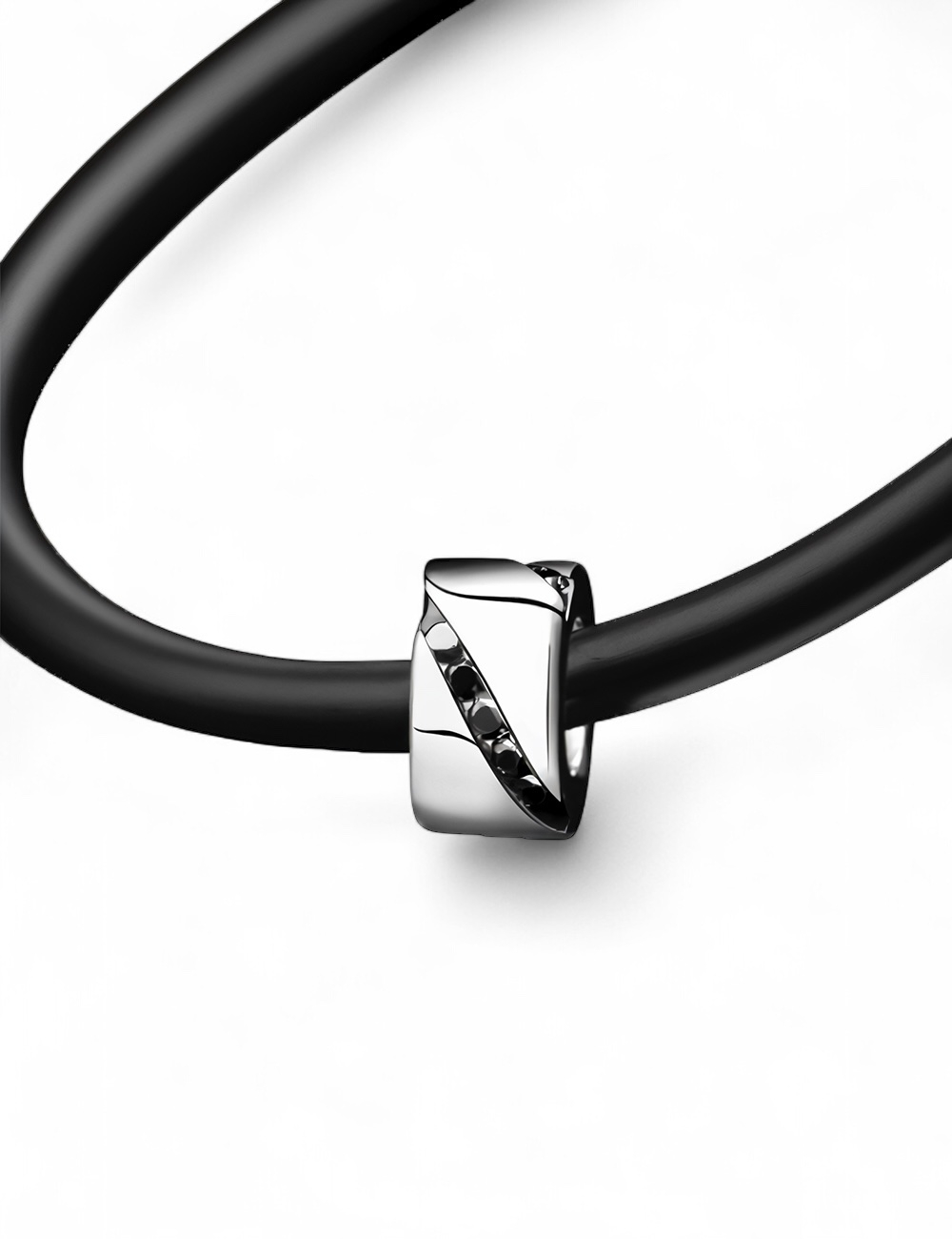 Men's white gold pendant with black diamonds on black cord.