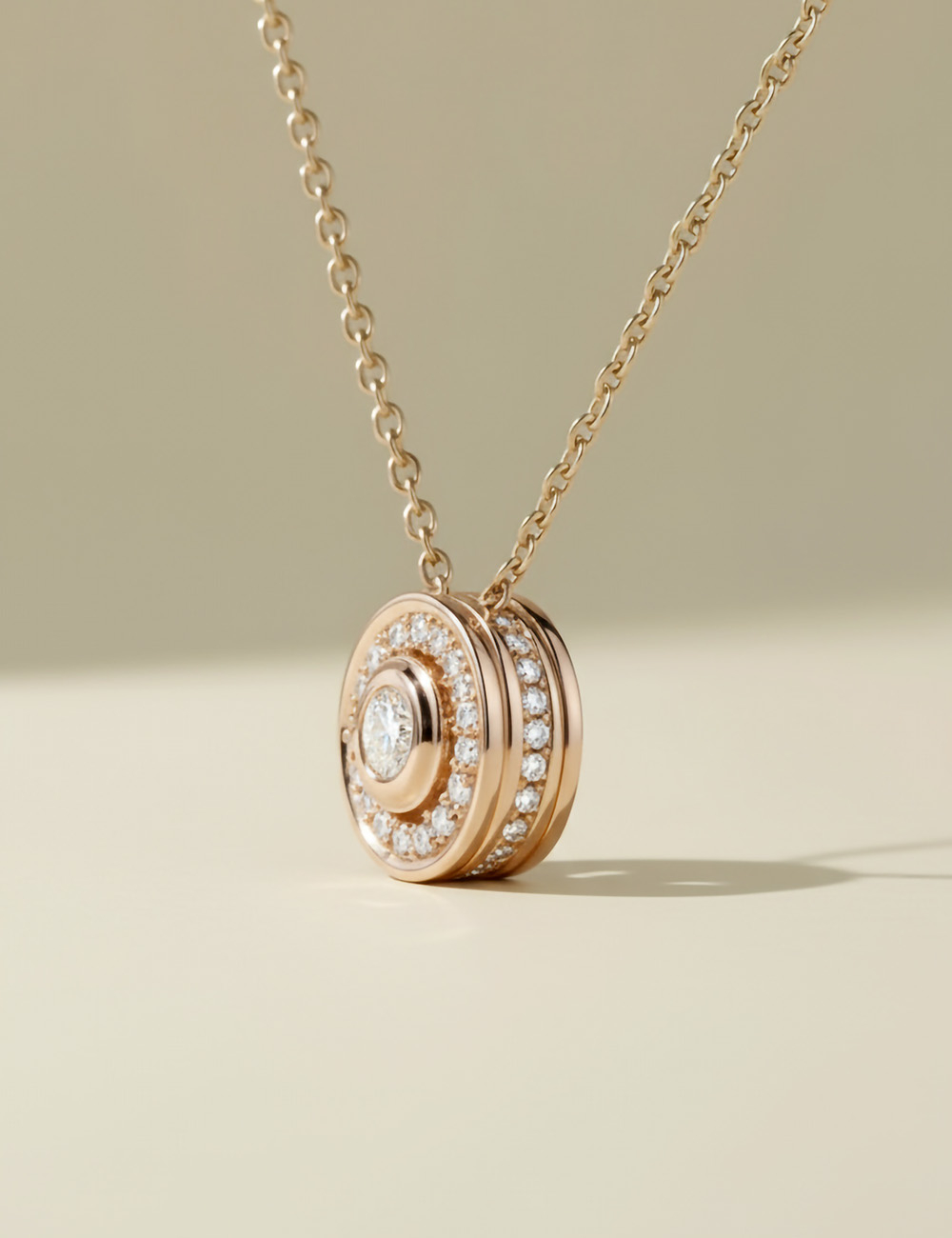 18k rose gold diamond pendant featuring an elegant pavé halo.
