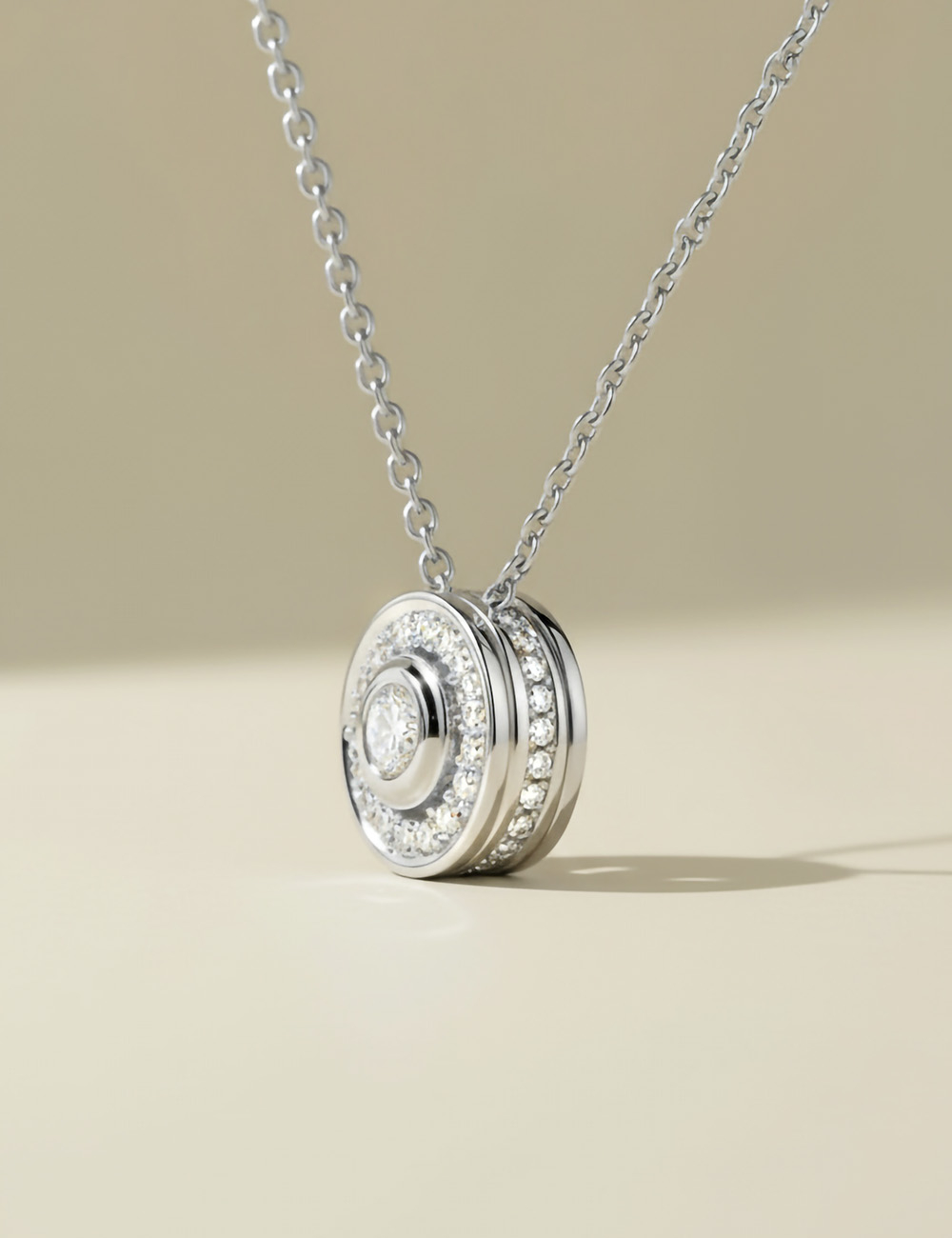 18k white gold diamond pendant with pavé diamond halo setting.