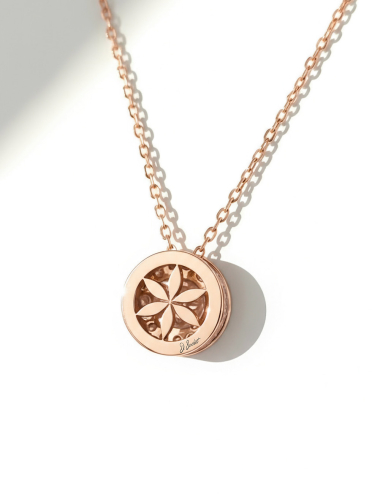 Back of 18k rose gold pendant featuring openwork flower-of-life design and diamonds.