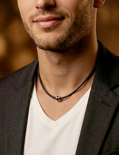 Rose gold pendant with black diamonds on black cord, graphic men’s jewelry design.