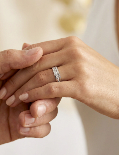 Women's platinum wedding band with grain-set white diamonds, modern and contrasting design, refined jewelry elegance.