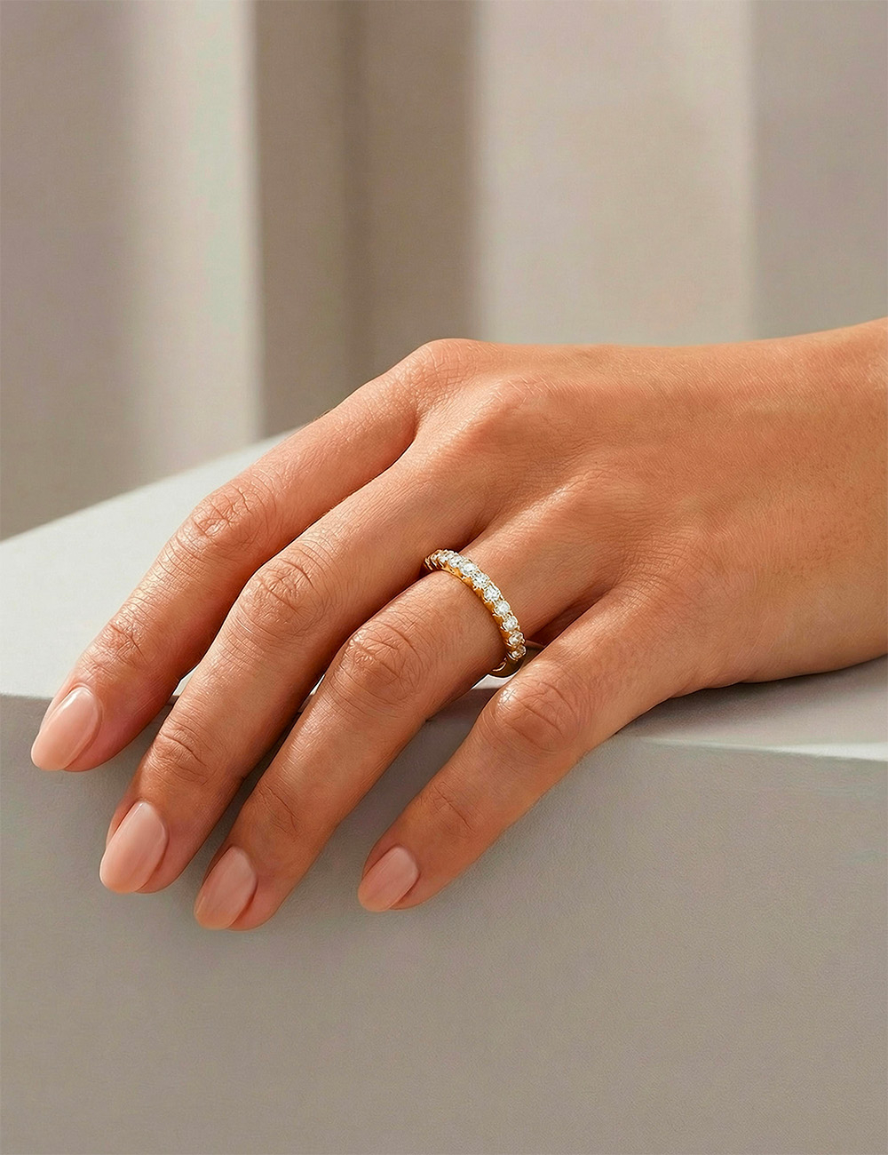 Women’s yellow gold wedding band with natural white diamonds in a prong setting, a refined and luminous D.Bachet design.