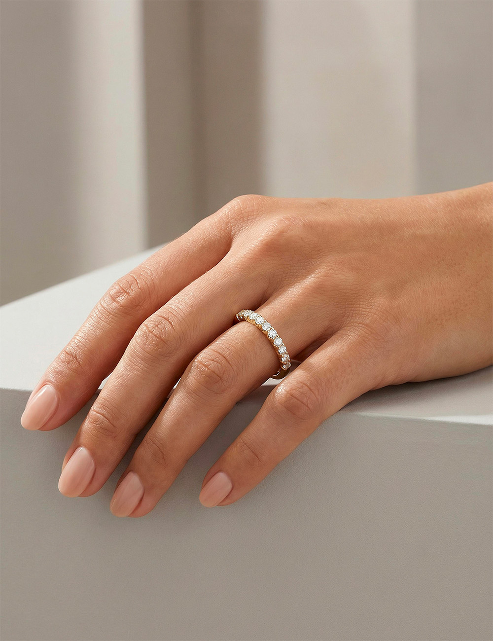 Women’s rose gold band, natural white diamonds in prong setting, refined wedding ring.