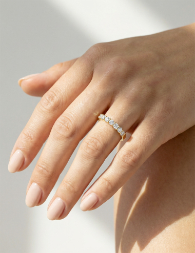 Yellow gold women’s band with natural white diamonds in claw setting, timeless bright ring design.