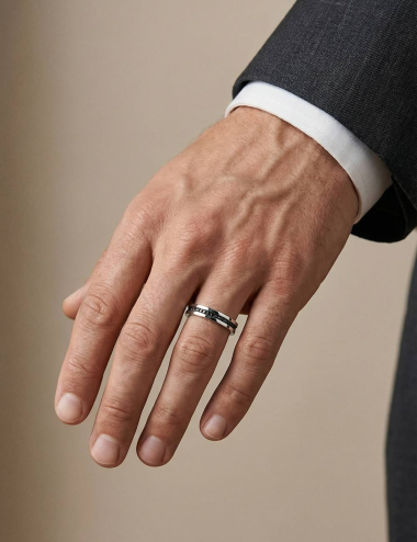 Platinum men’s ring with a line of black diamonds and a clean, graphic silhouette.