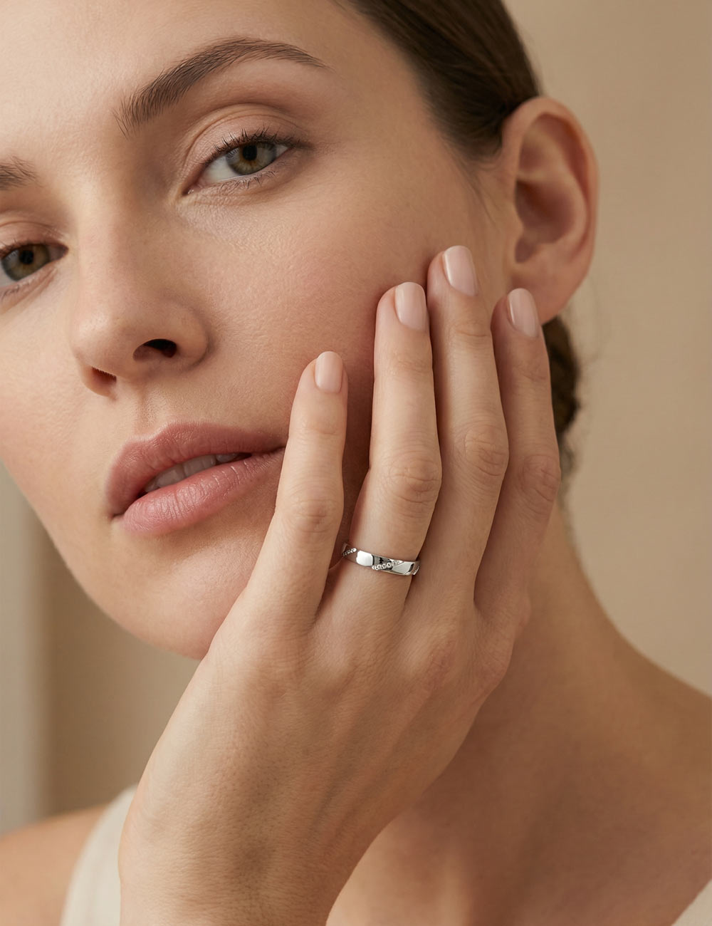 Women’s platinum wedding band set with white diamonds in a diagonal line, clean design and polished finish.