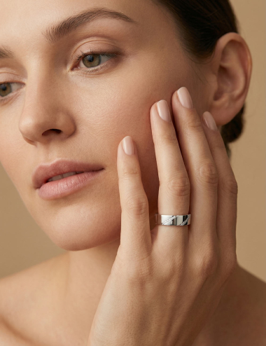 Women’s platinum wedding band featuring a contemporary design with white diamonds set in a diagonal line.