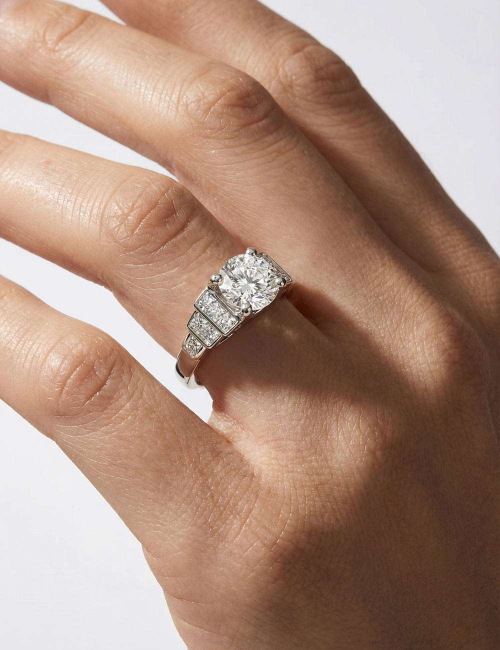 Empire engagement ring in platinum with a 2-carat natural white diamond, visible from the side.