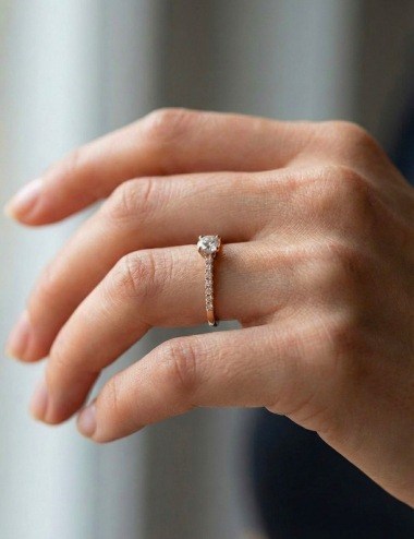 Rose gold engagement ring set with seven white diamonds, featuring a 0.50 ct center diamond and clean, contemporary lines.