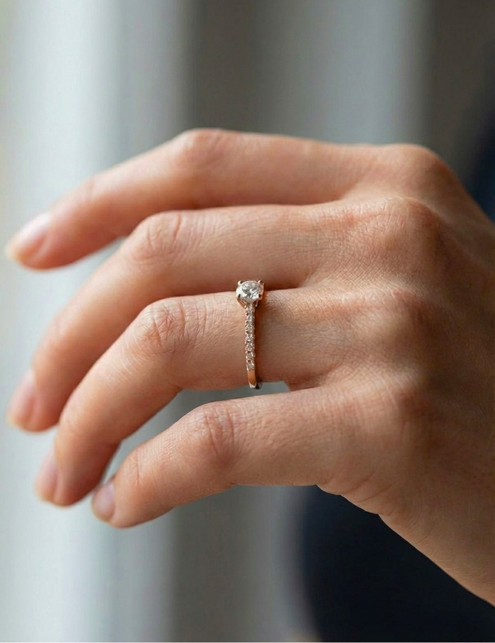 Rose gold engagement ring set with seven white diamonds, featuring a 0.50 ct center diamond and clean, contemporary lines.
