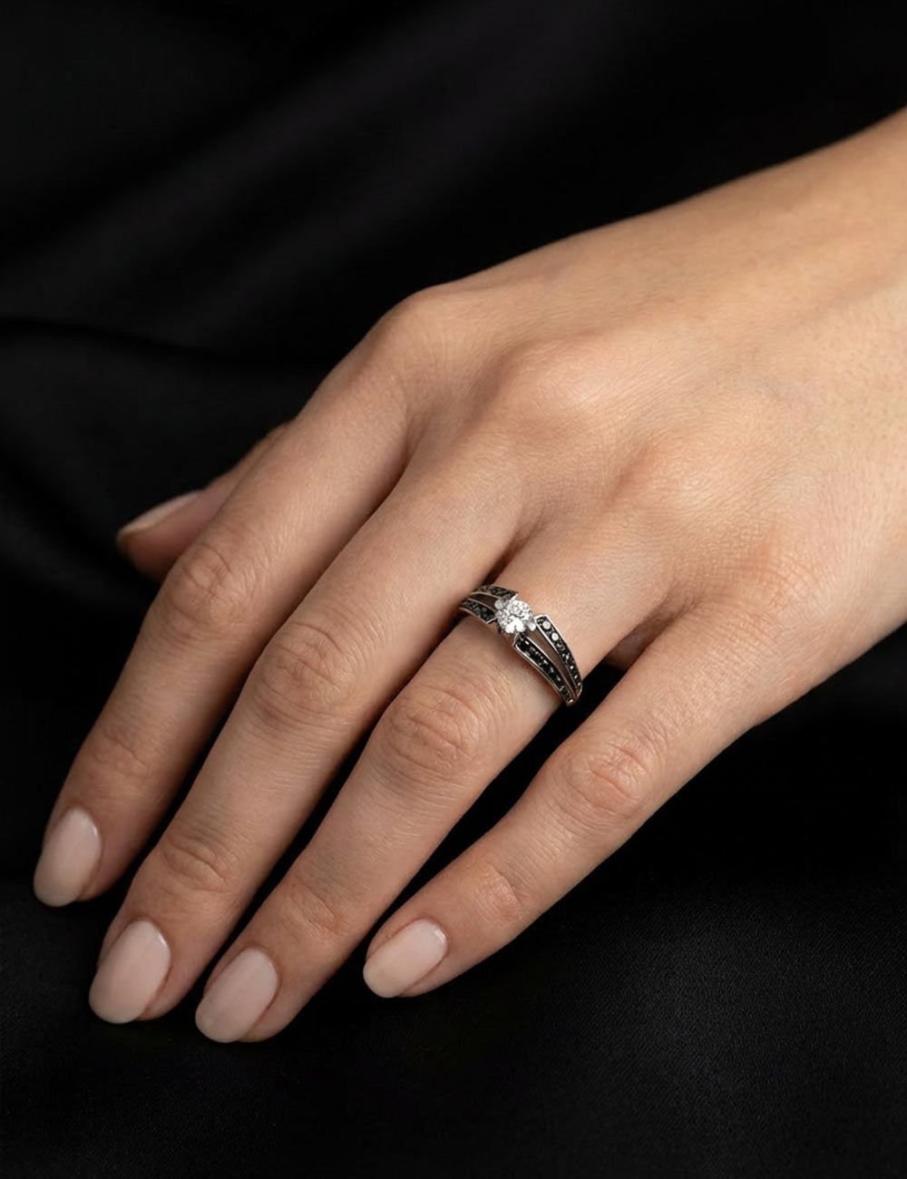 Bague de fiançailles en platine avec diamant blanc naturel central et pavage de diamants noirs.