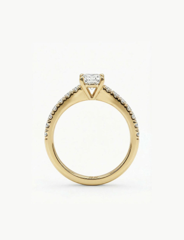 Yellow gold solitaire ring with a 0.50 carat white diamond side view and pavé diamonds.