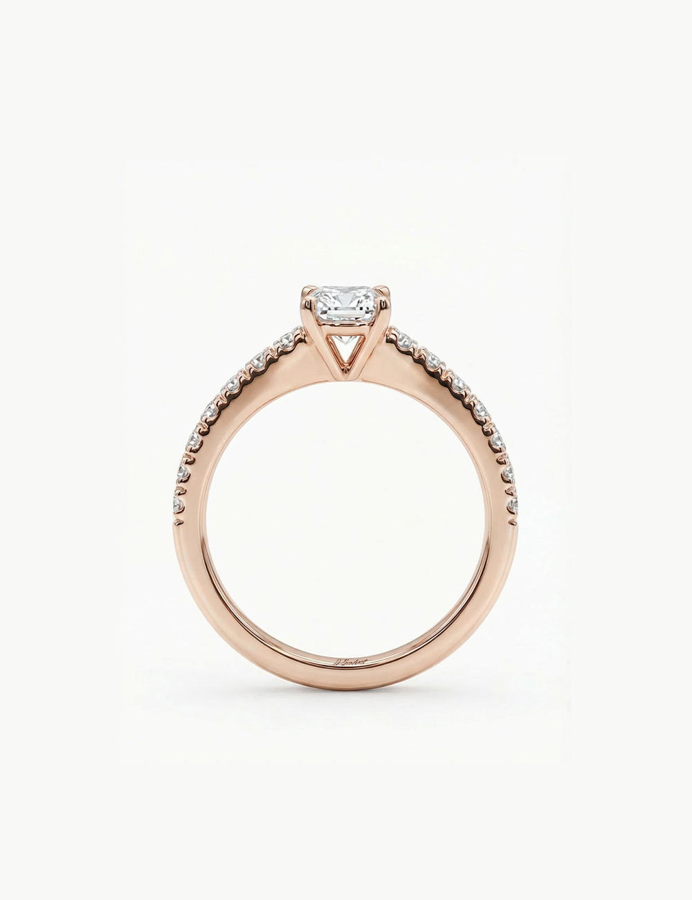 Rose gold solitaire ring with a 0.50 carat white diamond side view and pavé diamonds.