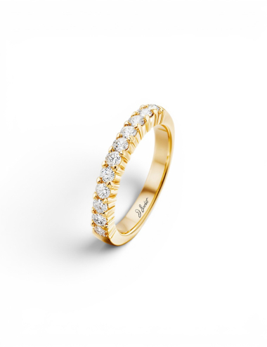 Women’s yellow gold wedding band with natural white diamonds in a prong setting.