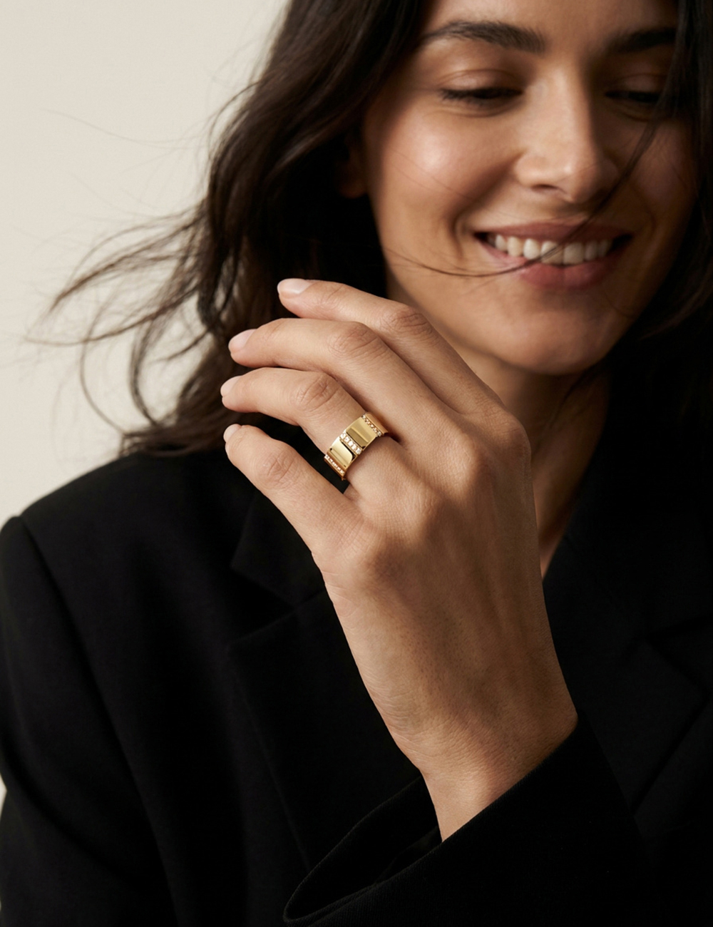 A Bridge to Unity large 18k yellow gold and diamond wedding band worn with a black blazer, architectural creation by D.Bachet.