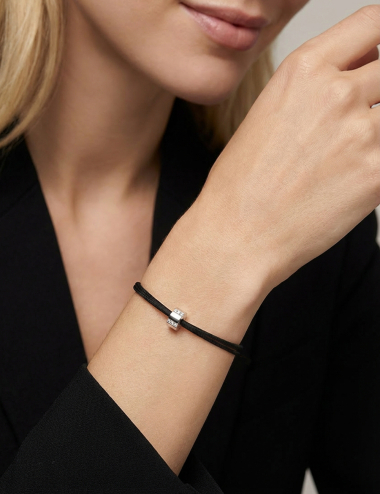 White gold and diamond cord bracelet A Bridge to Unity worn alone on the wrist D.Bachet.