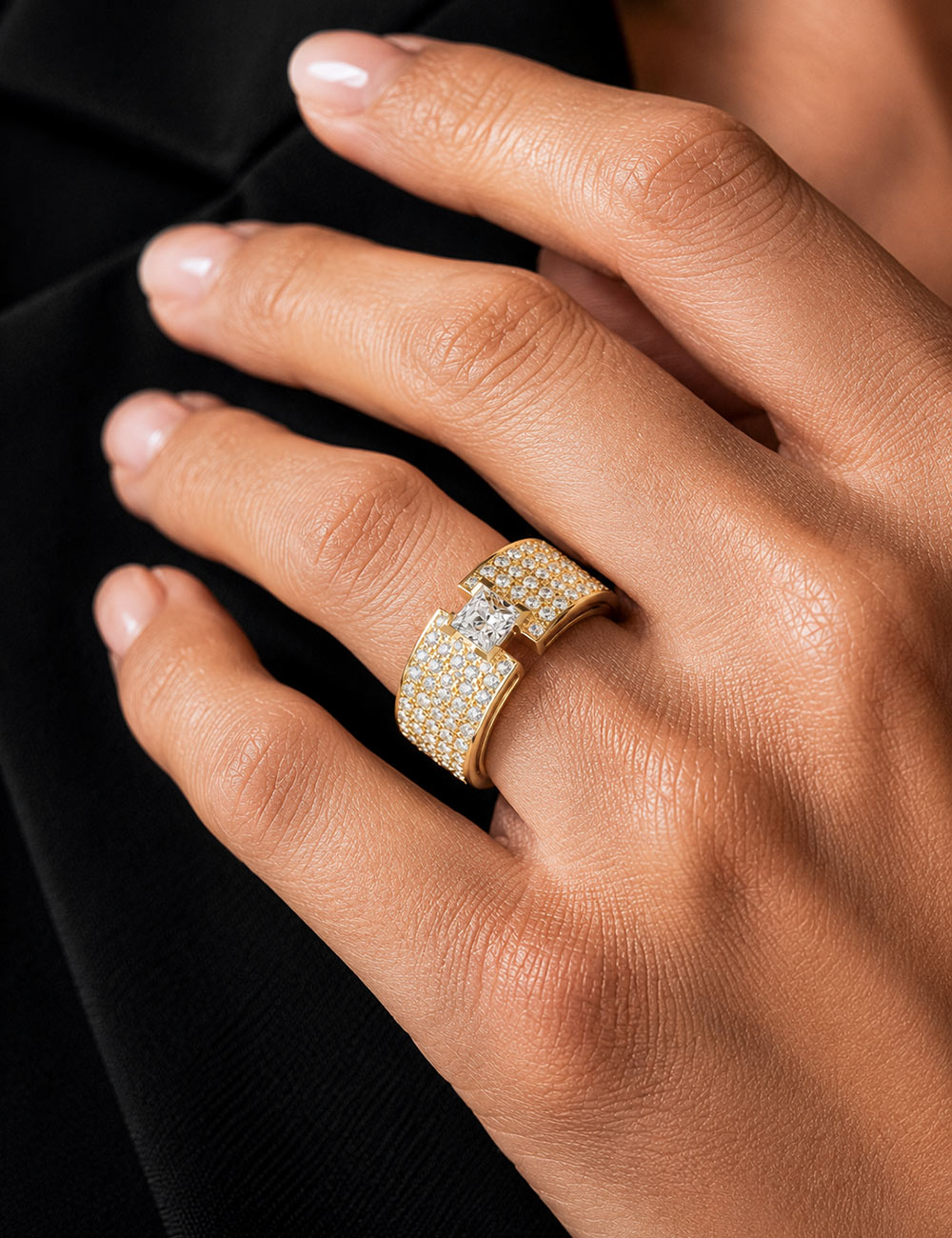 Luxury Shine white diamond ring in 18k yellow gold by D.Bachet worn on a finger.