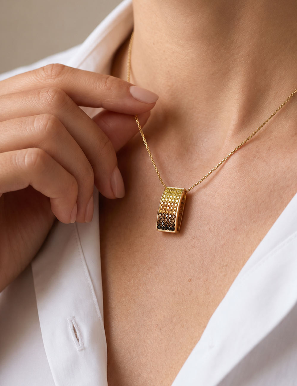 18k yellow gold pendant with a pavé of fancy yellow, champagne and cognac diamonds on a yellow gold chain.