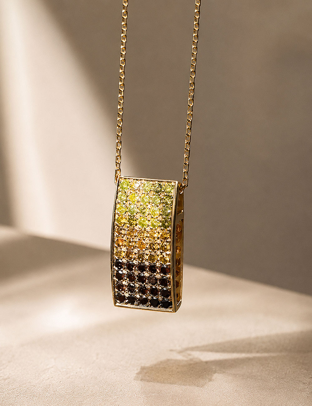 18k yellow gold pendant with a pavé of fancy yellow, champagne and cognac diamonds on a yellow gold chain.