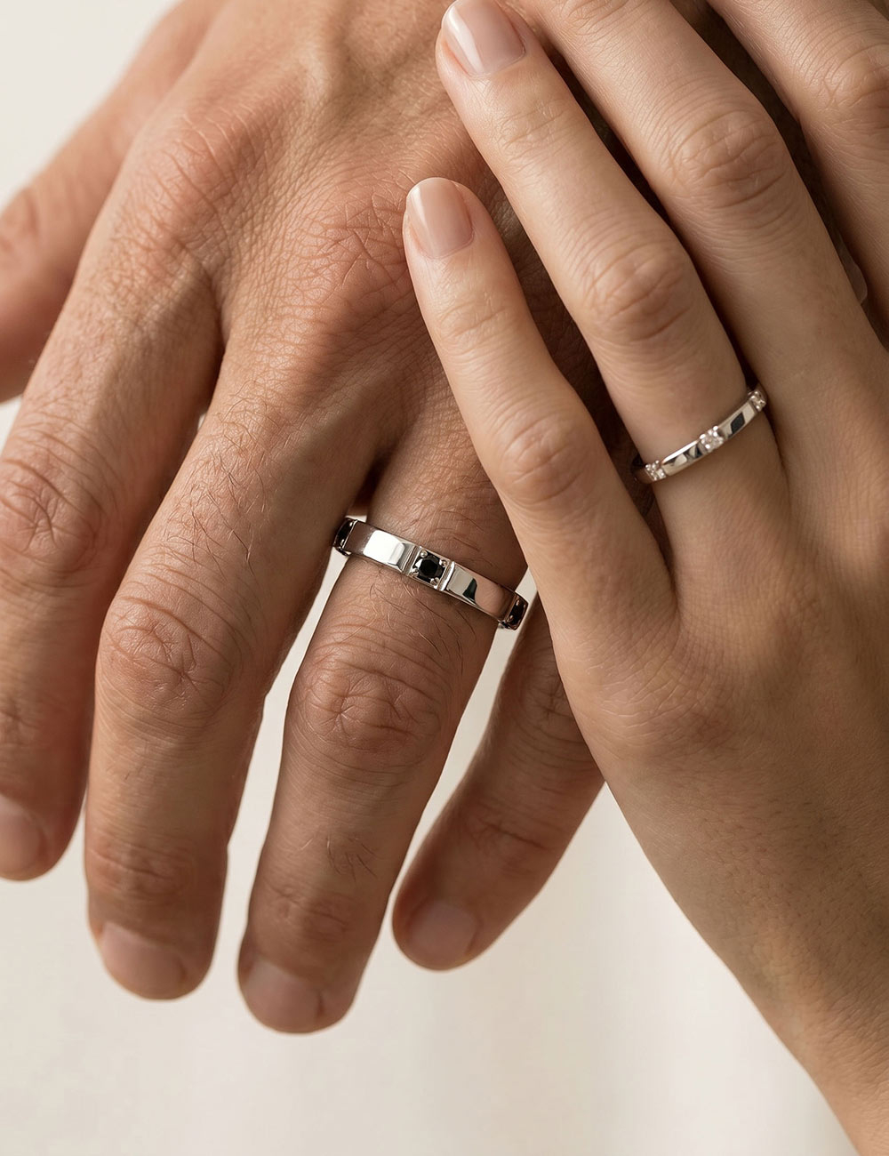 Gravity women's platinum 950 wedding band with white diamonds, worn as a couple.