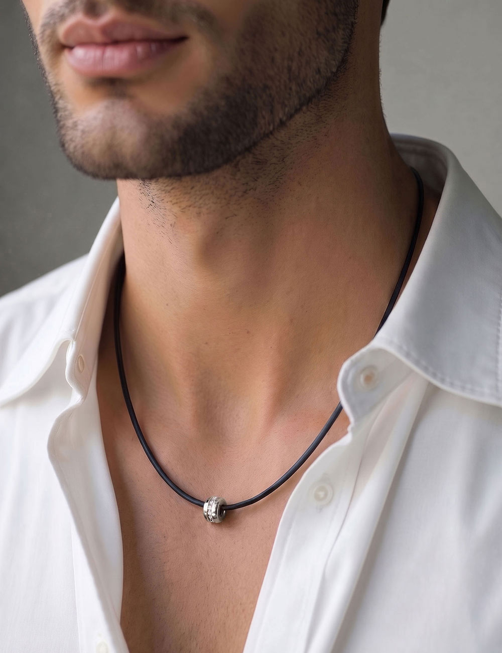 D.Bachet A Way to Love men's pendant in 18k white gold and channel-set white diamonds, on a matte black silicone cord.
