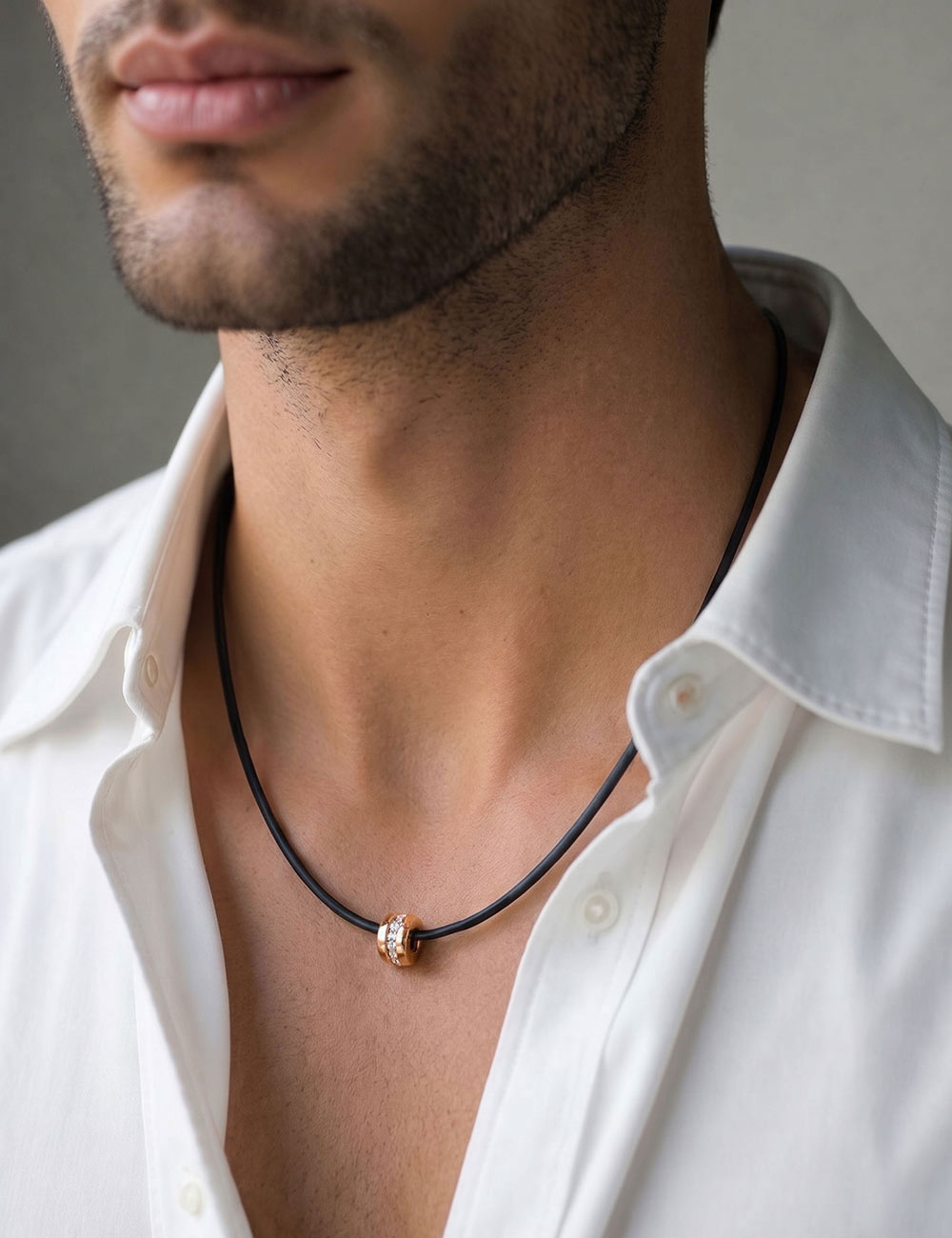 Designer jewelry for men: D.Bachet A Way to Love pendant in 18k rose gold and white diamonds worn by a model.