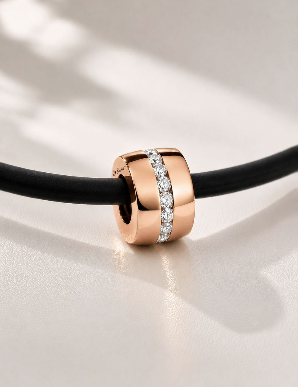 D.Bachet A Way to Love men's necklace: 18k rose gold and white diamond pendant on a black silicone cord.
