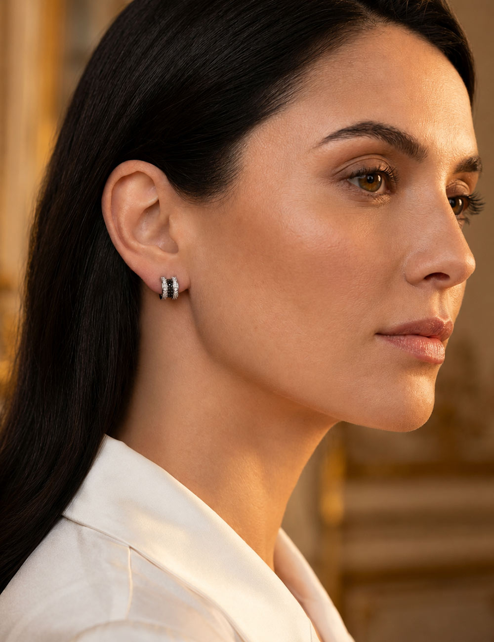 Scroll in Love 18-carat white gold huggie earrings set with white and black diamonds.