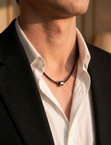 D.Bachet Bridge to Unity pendant in white gold with black diamonds worn on black cord.