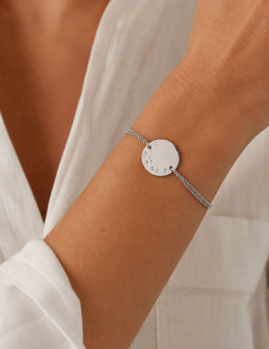 Cascade Medallion bracelet in 18K white gold set with white diamonds, worn on the wrist.