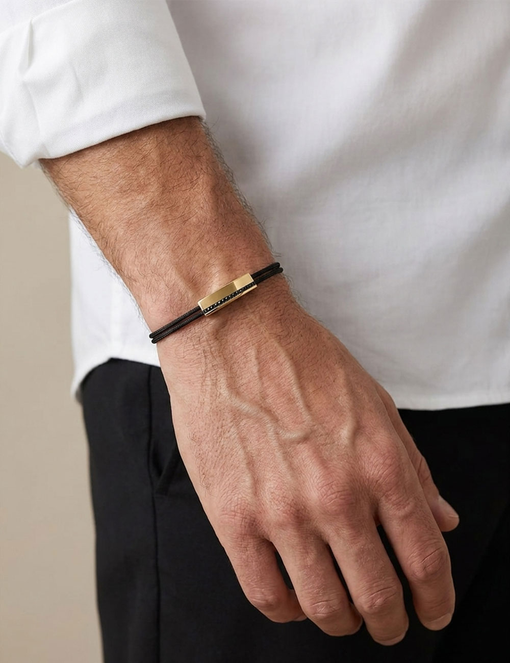 Perfect men's bracelet in 18k yellow gold and black diamonds on a black cord.