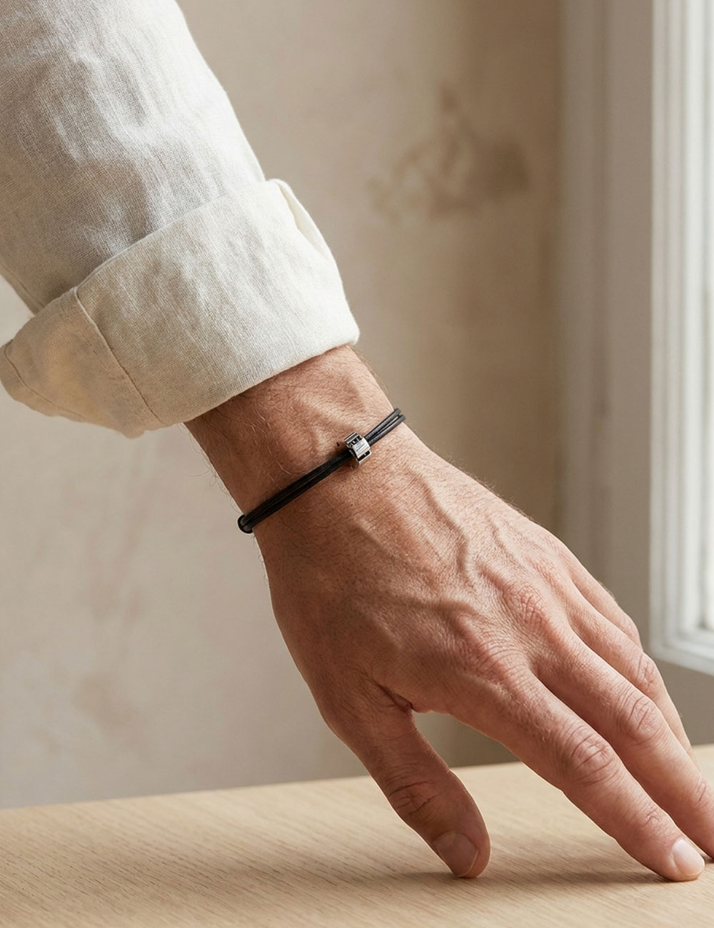Contemporary men's bracelet in 750 white gold with black diamonds, set on an adjustable black cotton cord.