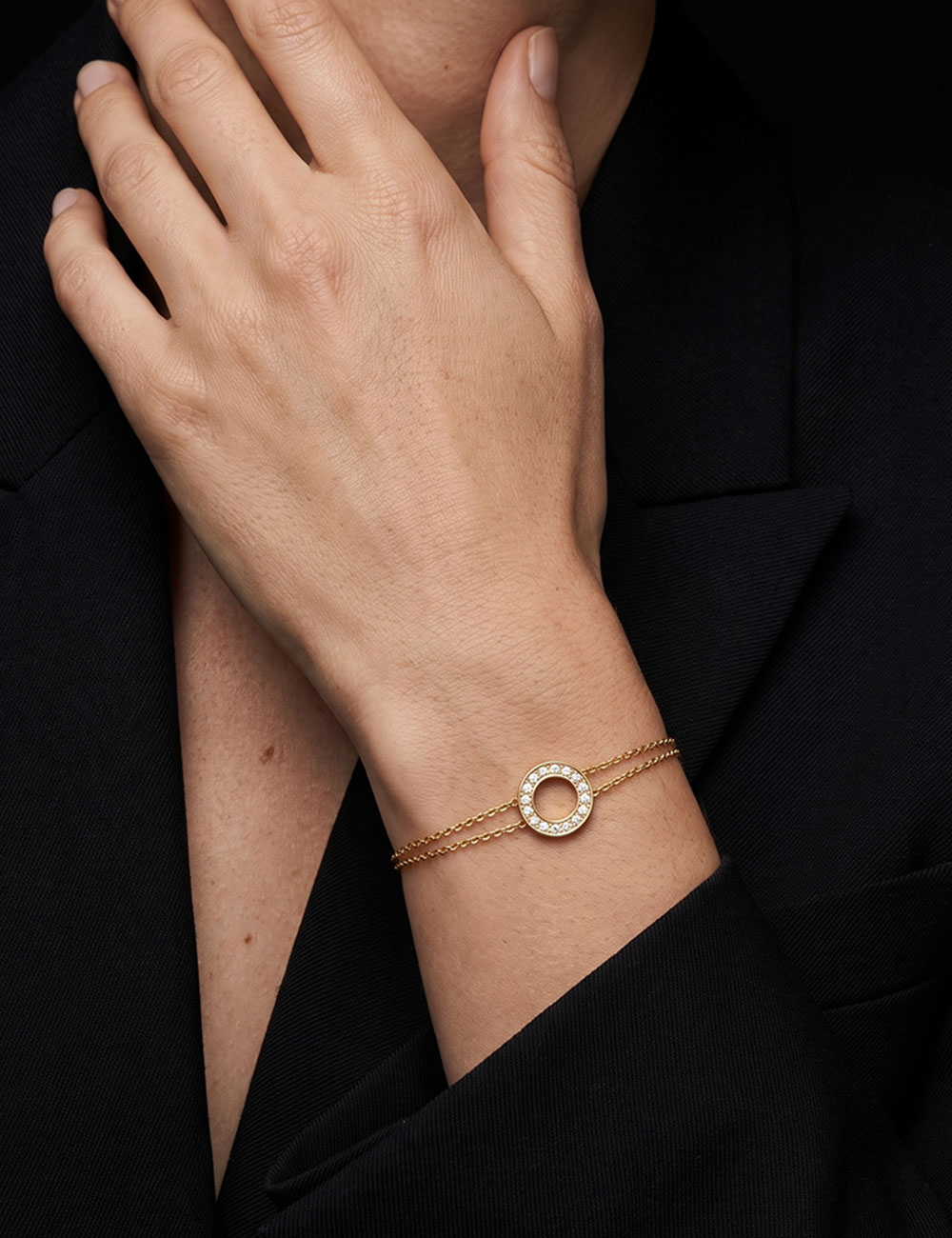 Cercle women’s circle bracelet in 18k rose gold with white diamonds worn on the wrist.